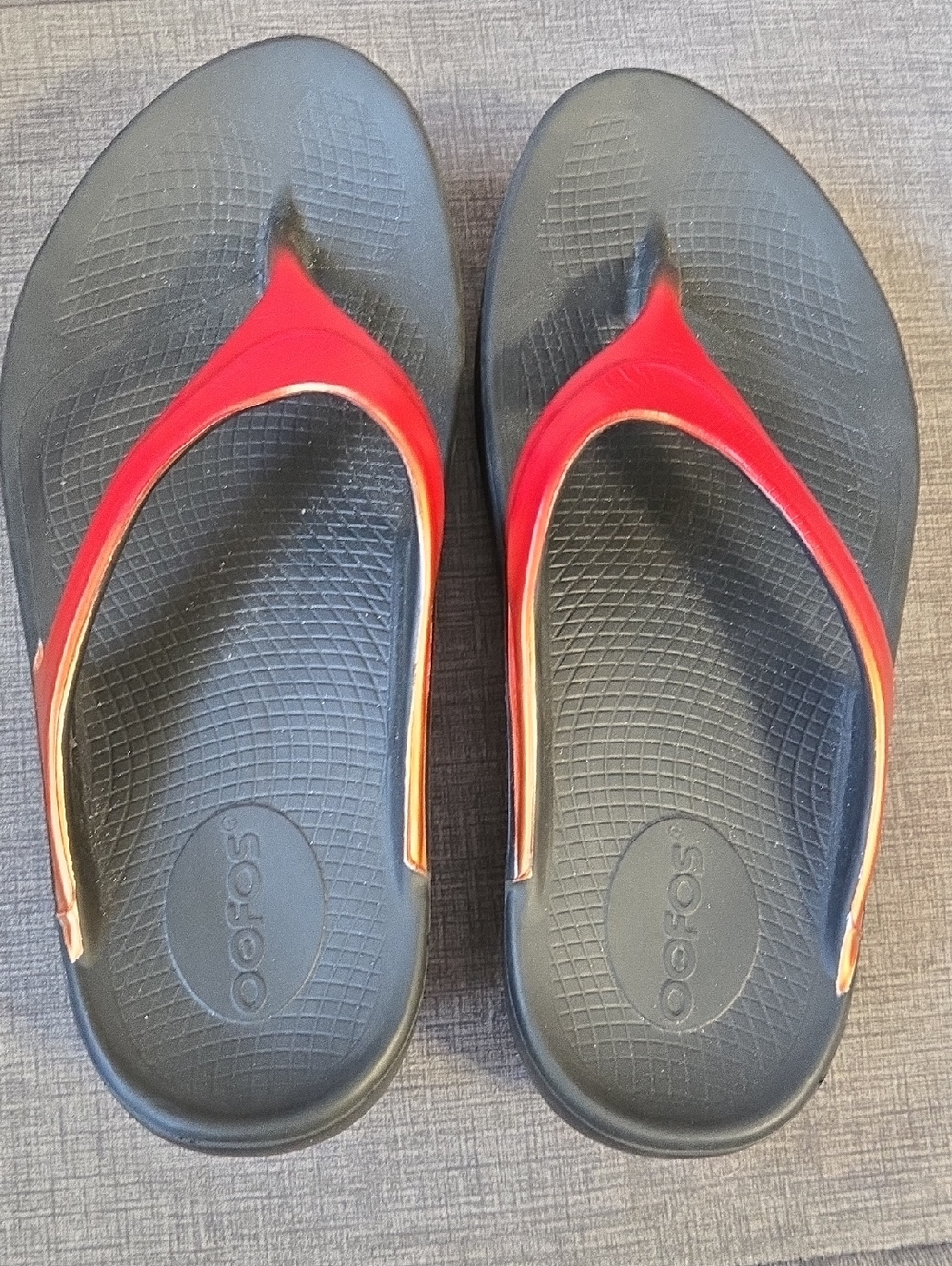 OOFOS Black Footbed Flip Flops with Red Straps and Orange Trim